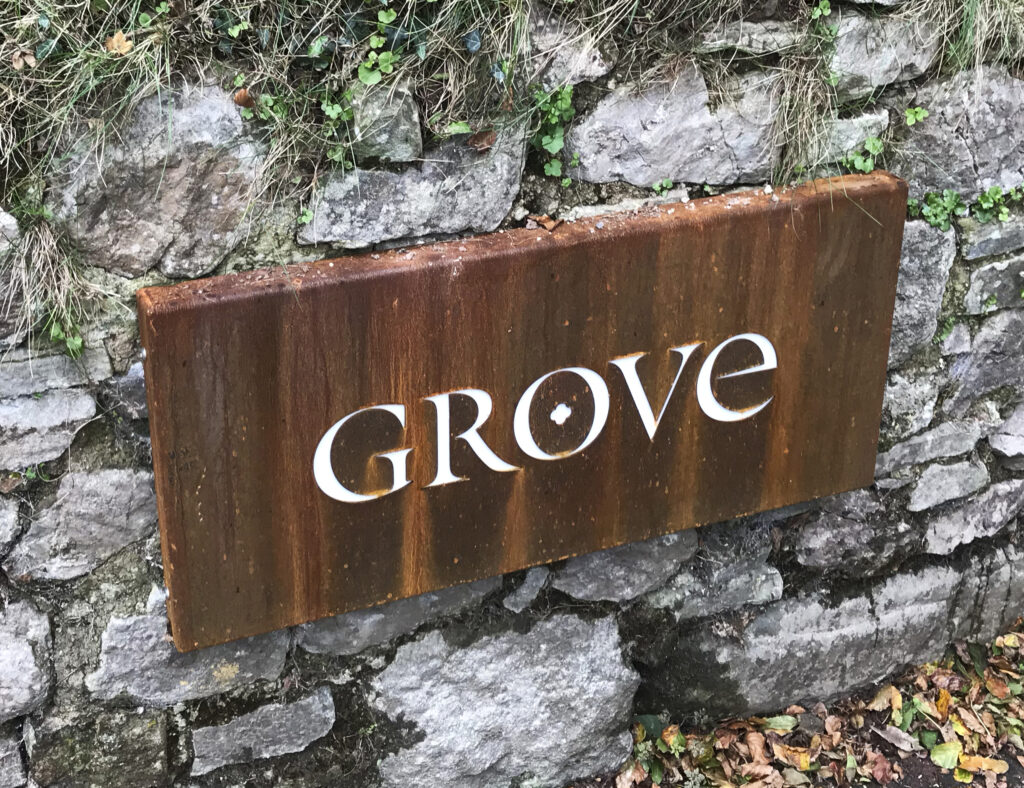The entrance sign to the Grove hotel featuring their logo