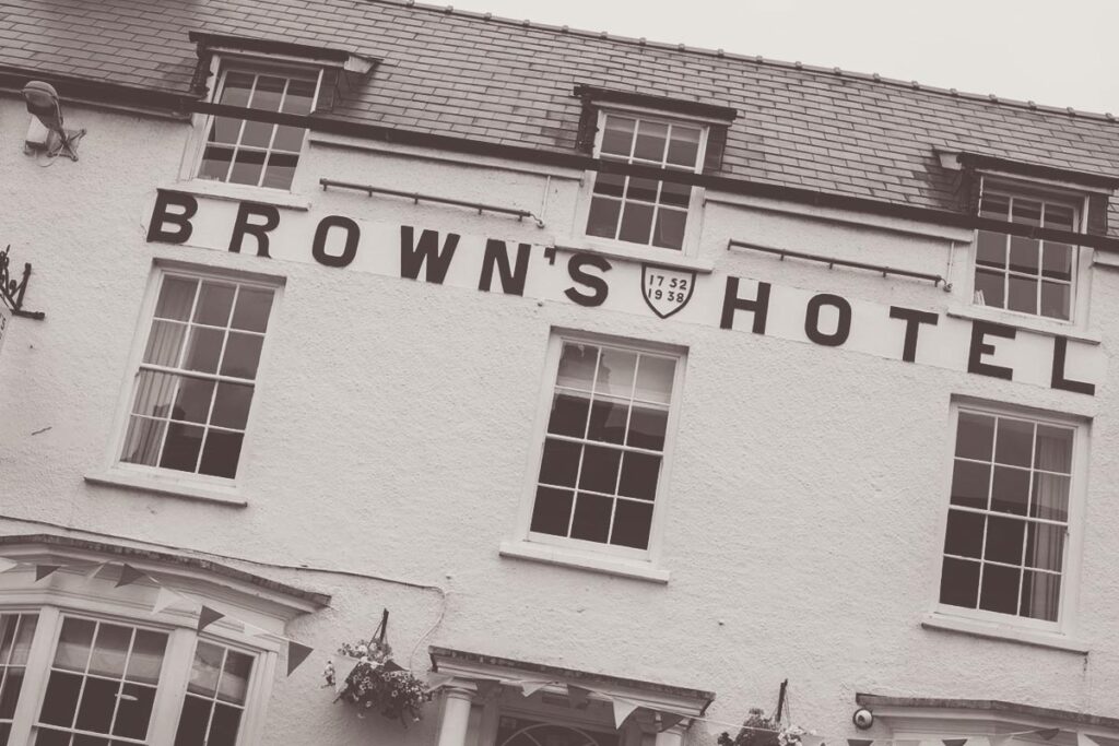 A black and white image of the exterior of Brown's Hotel, it is a historic building with the name built into the hotel