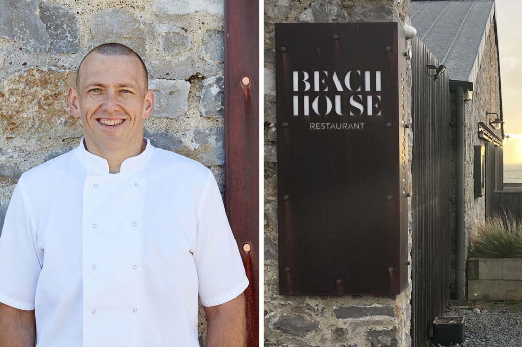 The Beach House's head chef stood outside of the restaurant with a sign with the Beach House logo design