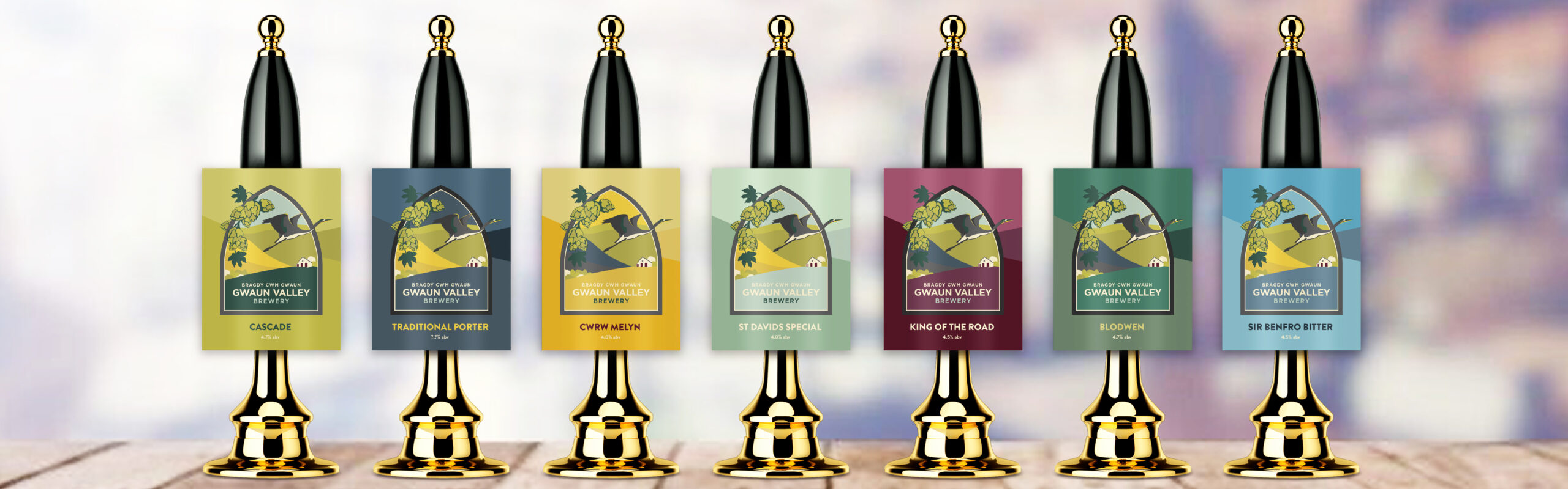 Beer pumps with labels designed by us, each in a different colour referencing the Pembrokeshire landscape