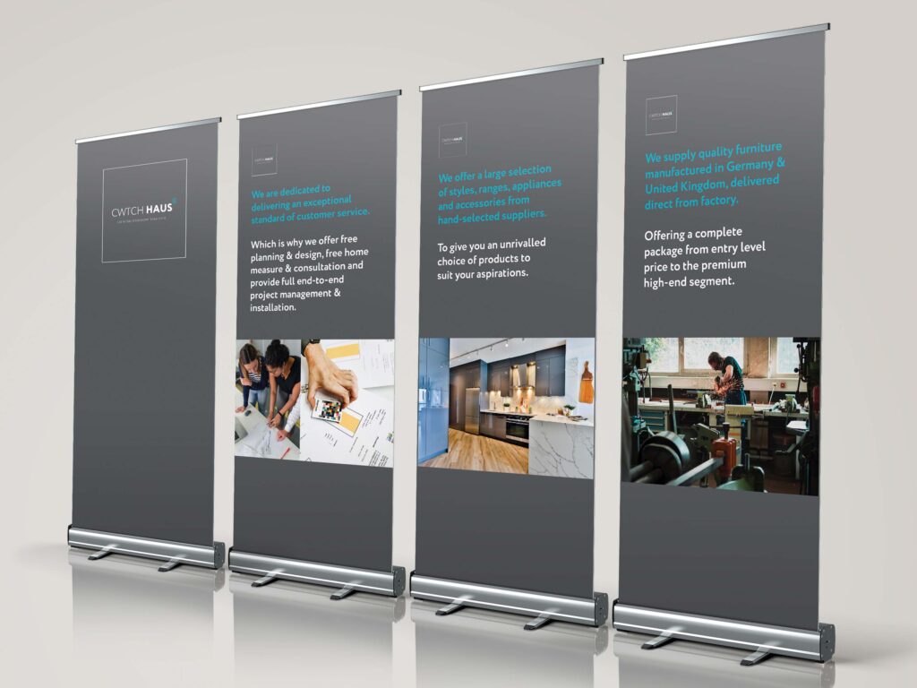 A series of roller banners in grey with white and blue text accents