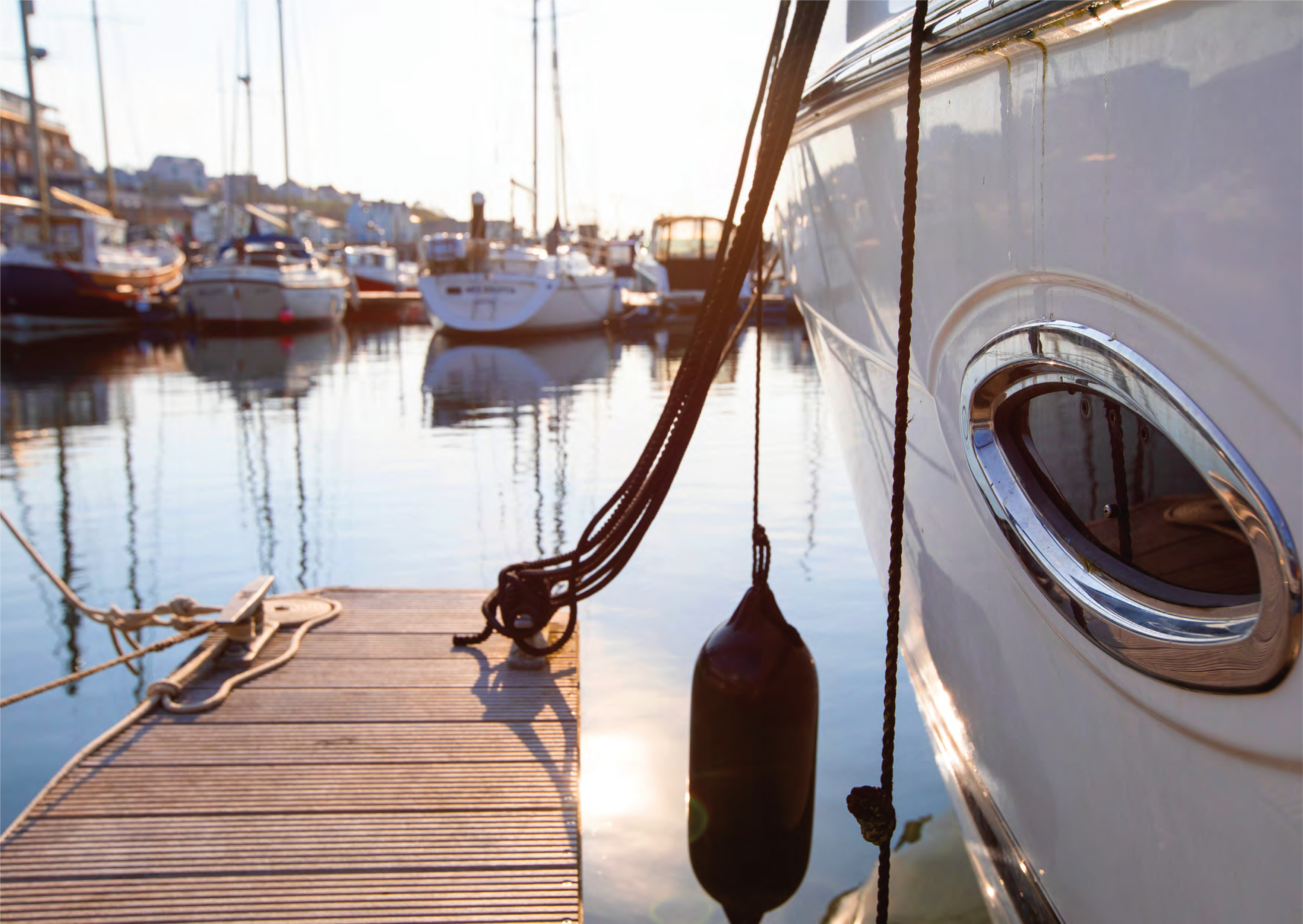 An image of a boat in the waterfront with a pier on the left