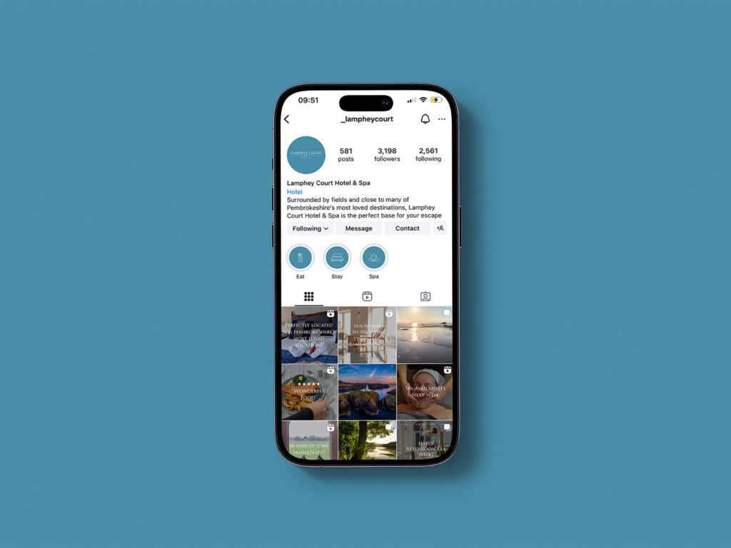 A blue background with an iphone showing the Instagram feed for Lamphey Court Hotel & Spa