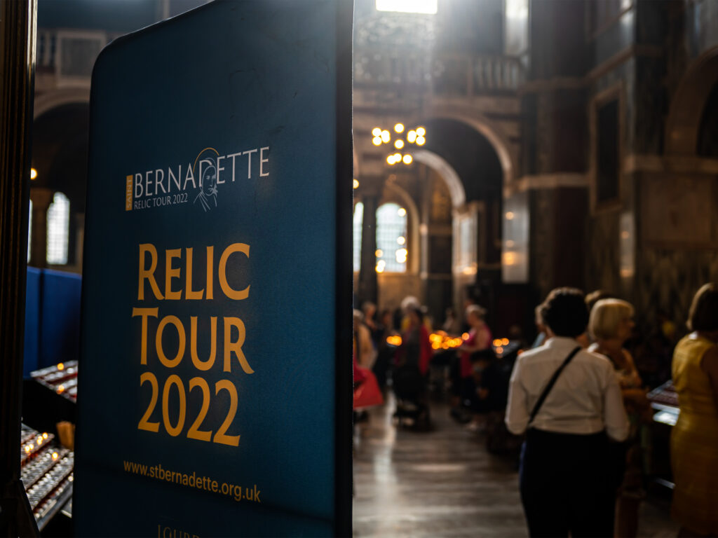 A display board in dark blue with the words 'RELIC TOUR 2022' in yellow