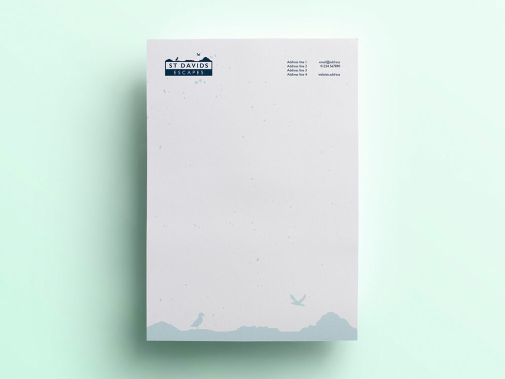 A letterhead with a pale green background, white paper, with a pale blue silhouette illustration along the bottom of the page, and the St Davids Escapes logo in the top left