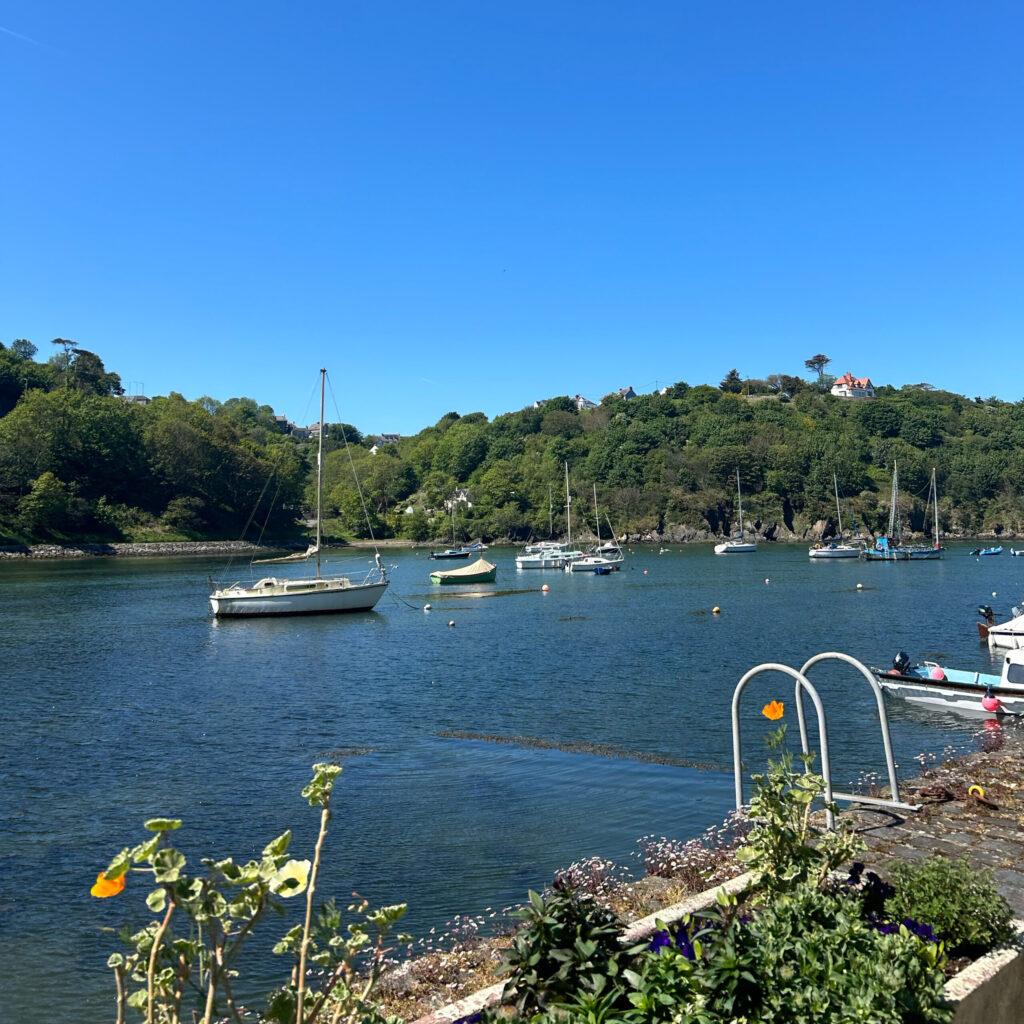 A view of a harbour on a sunny day with boats and a bright and clear blue sky